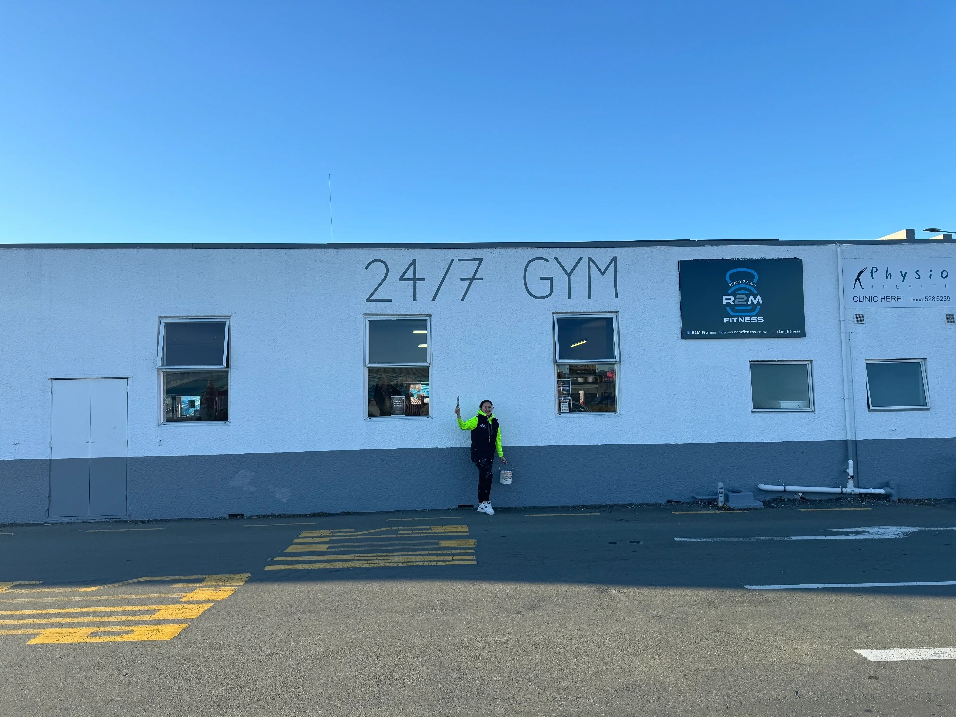 Commercial building exterior repaint in Nelson with completed signwriting area