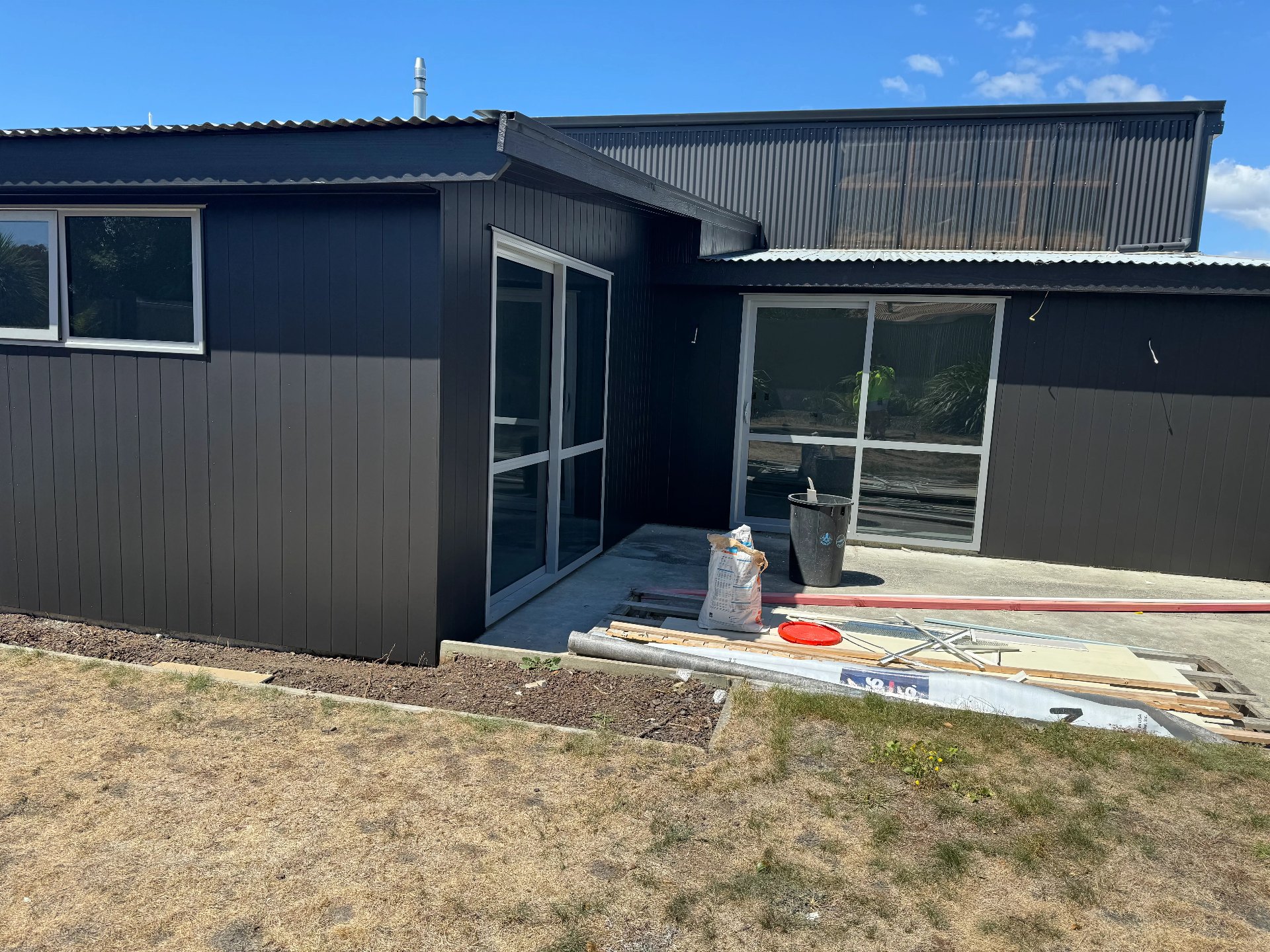 Modern charcoal weatherboard home exterior freshly painted, Nelson