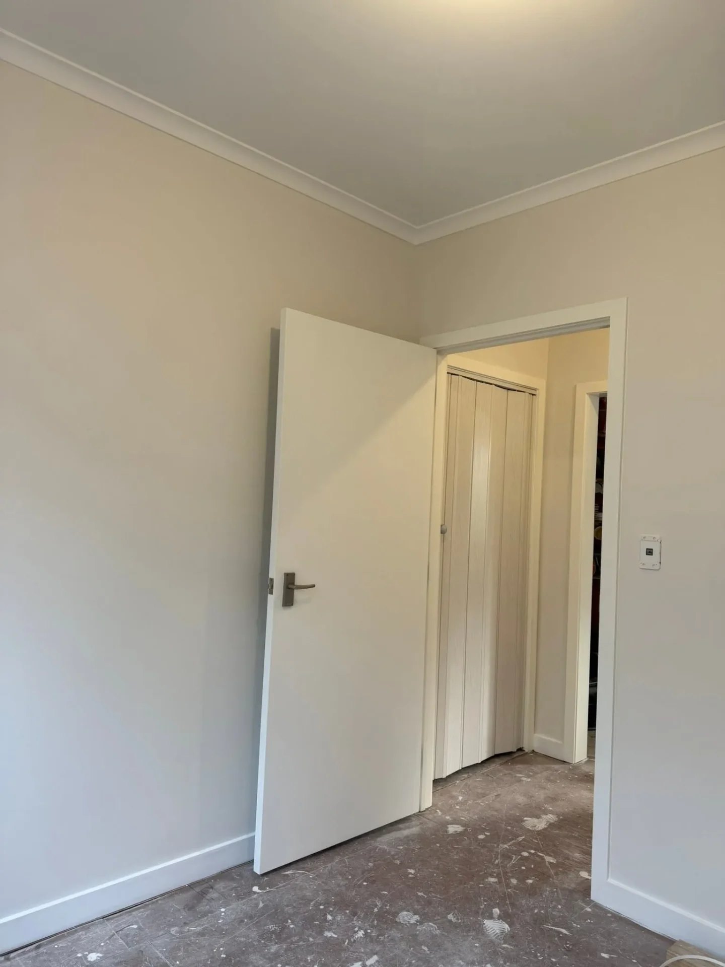 Interior repaint with white doors and smooth wall finish